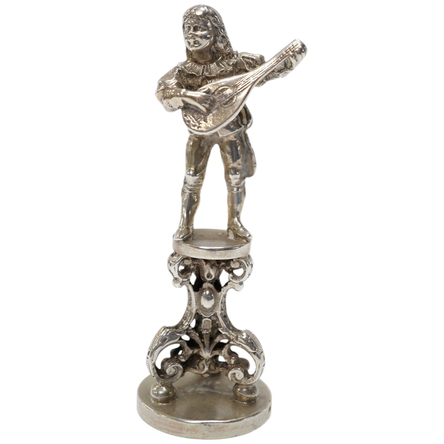 An early 20th century German 800 standard figural desk seal, modelled as a musician, 68mm. Condition - fair to good